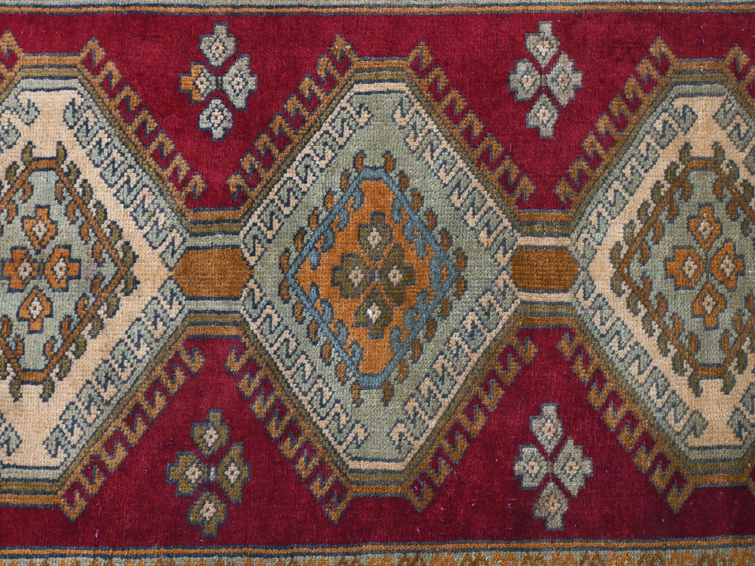 a close up of a rug with a red background