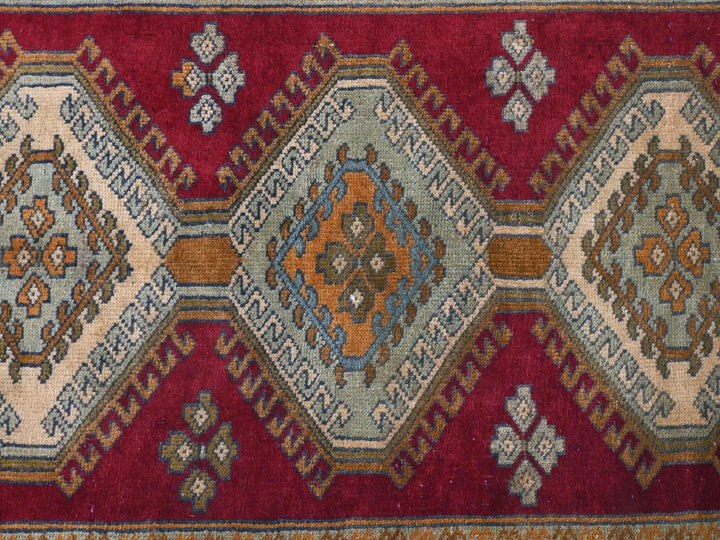 a close up of a rug with a red background