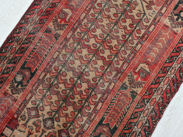 a red and black oriental rug on a white floor