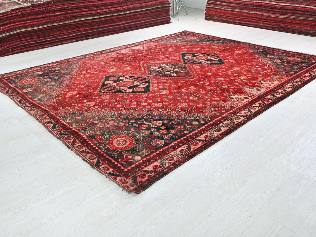 a red oriental rug on a white floor