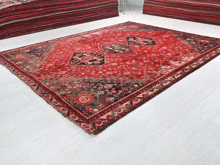 a red oriental rug on a white floor