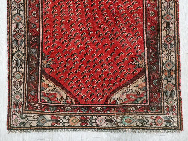 a red rug with an intricate design on it