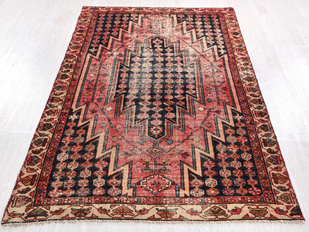a red and black rug on a white floor