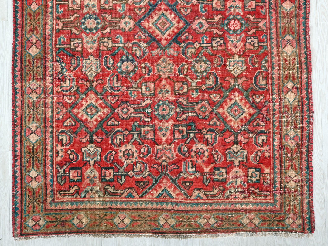 a red rug with a pattern on it