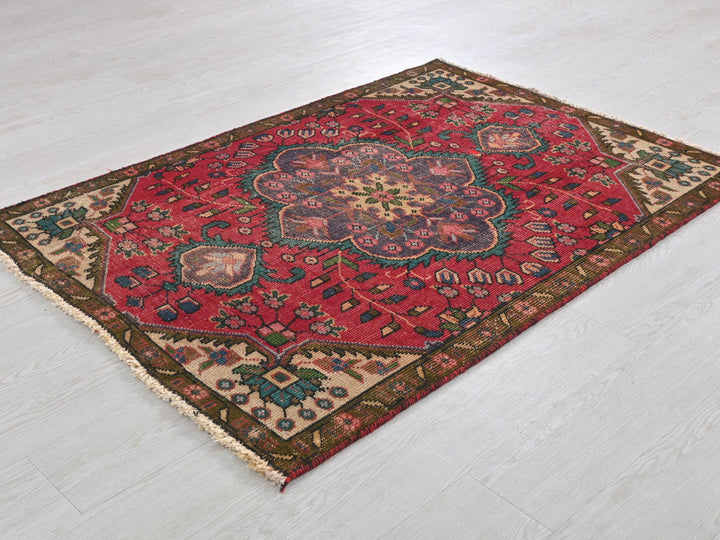 a red rug with a flower design on it