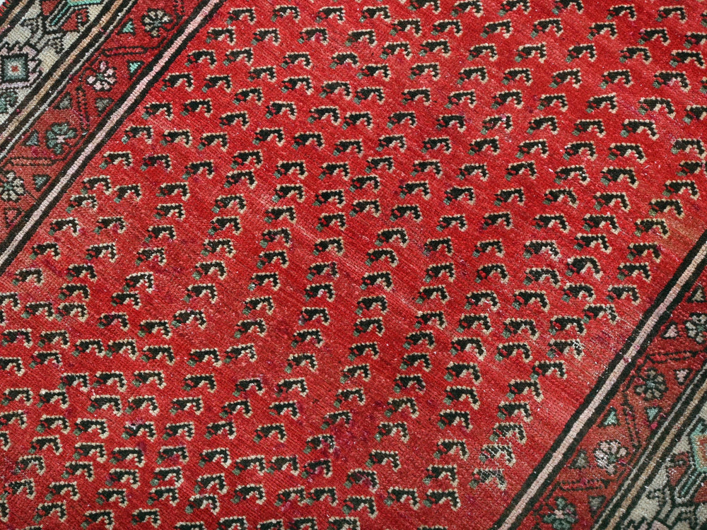 a close up of a red rug with elephants on it