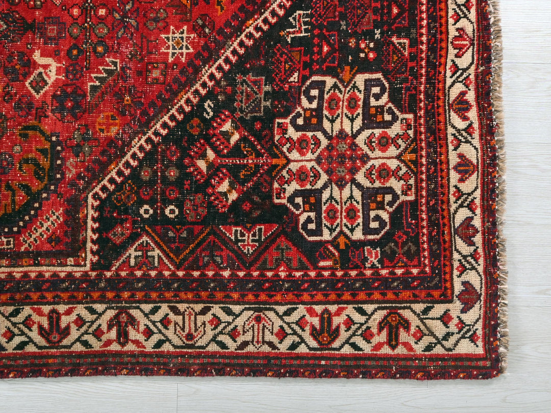 a red rug with an intricate design on it