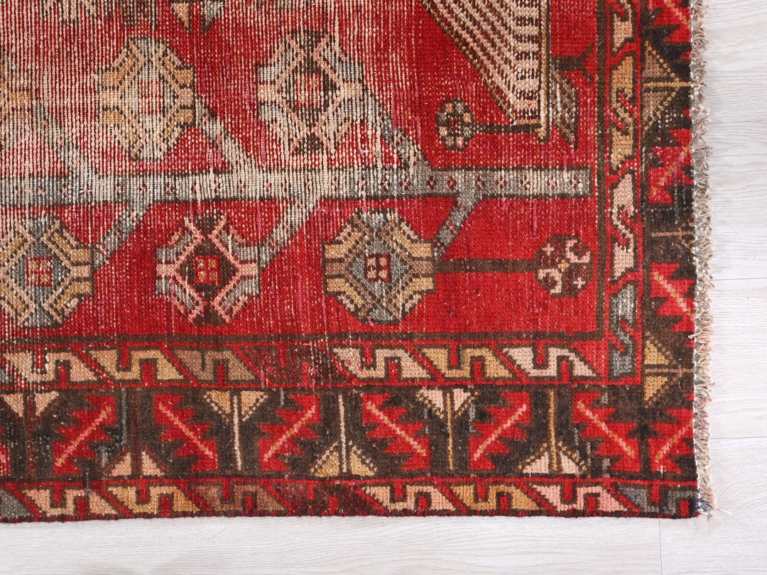 a red rug with a pattern on it