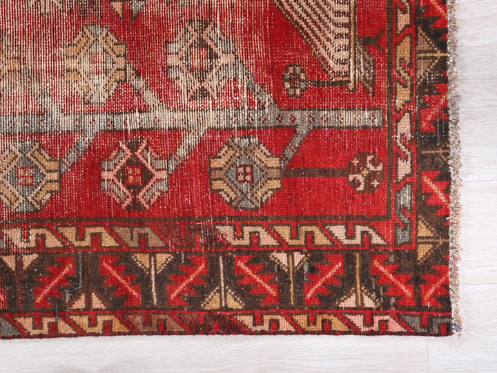 a red rug with a pattern on it