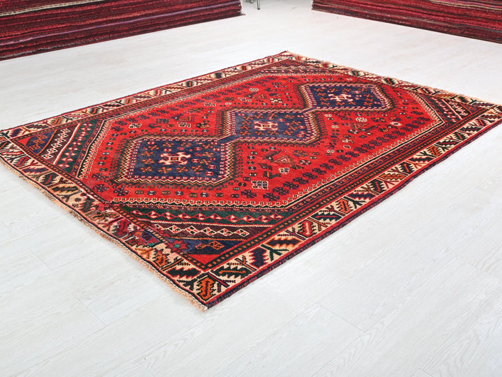 a red rug on the floor of a room