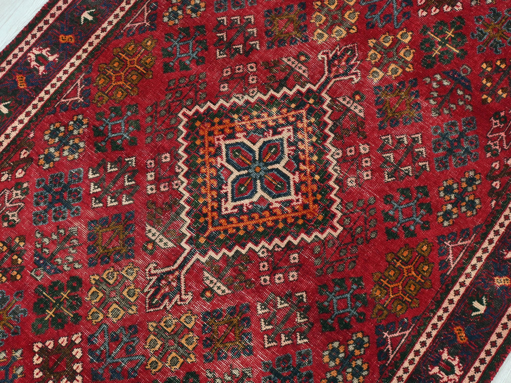 a red rug with a colorful design on it