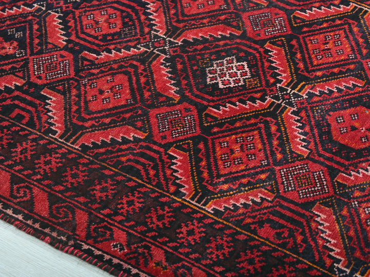 a close up of a red and black oriental rug