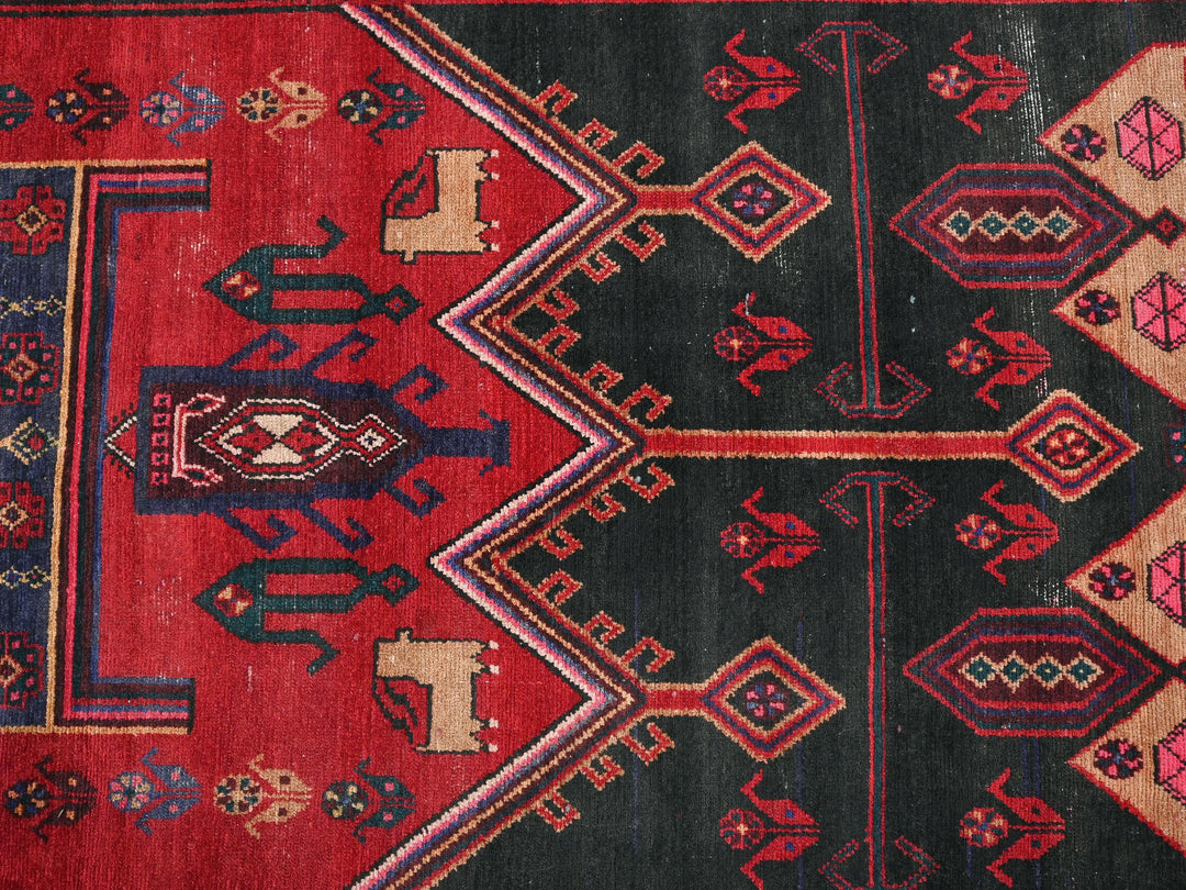 a red and black rug with a design on it