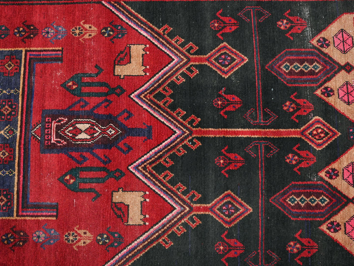 a red and black rug with a design on it