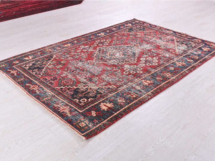 a red and blue rug on a white floor