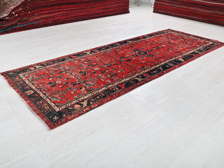 a red rug is laying on a white floor