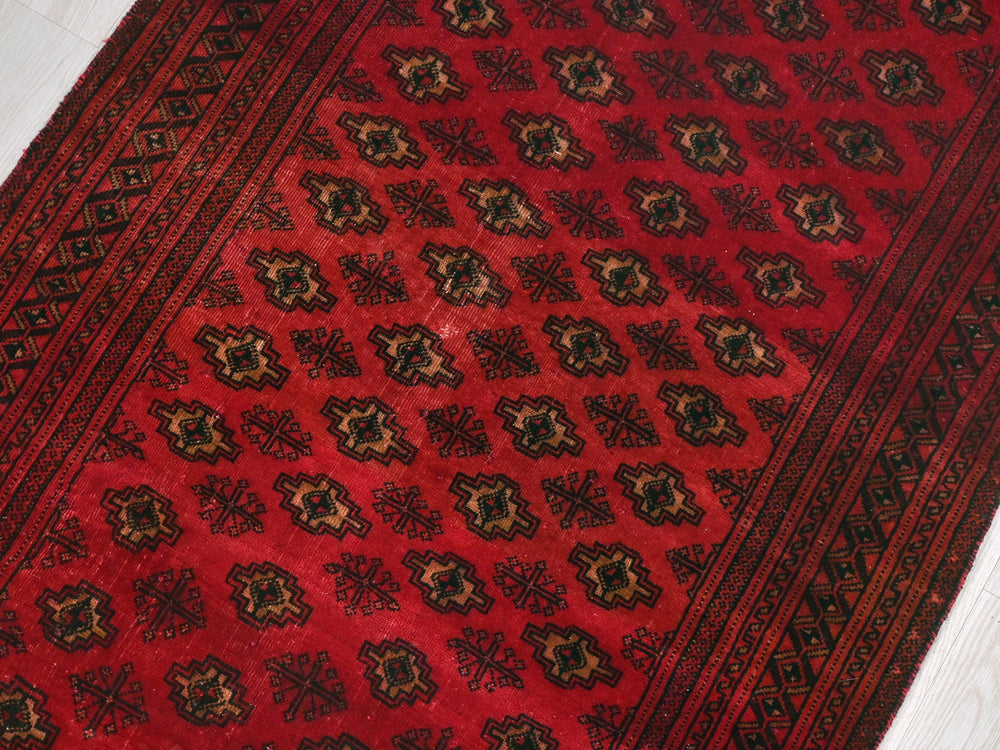 a red rug on the floor of a room
