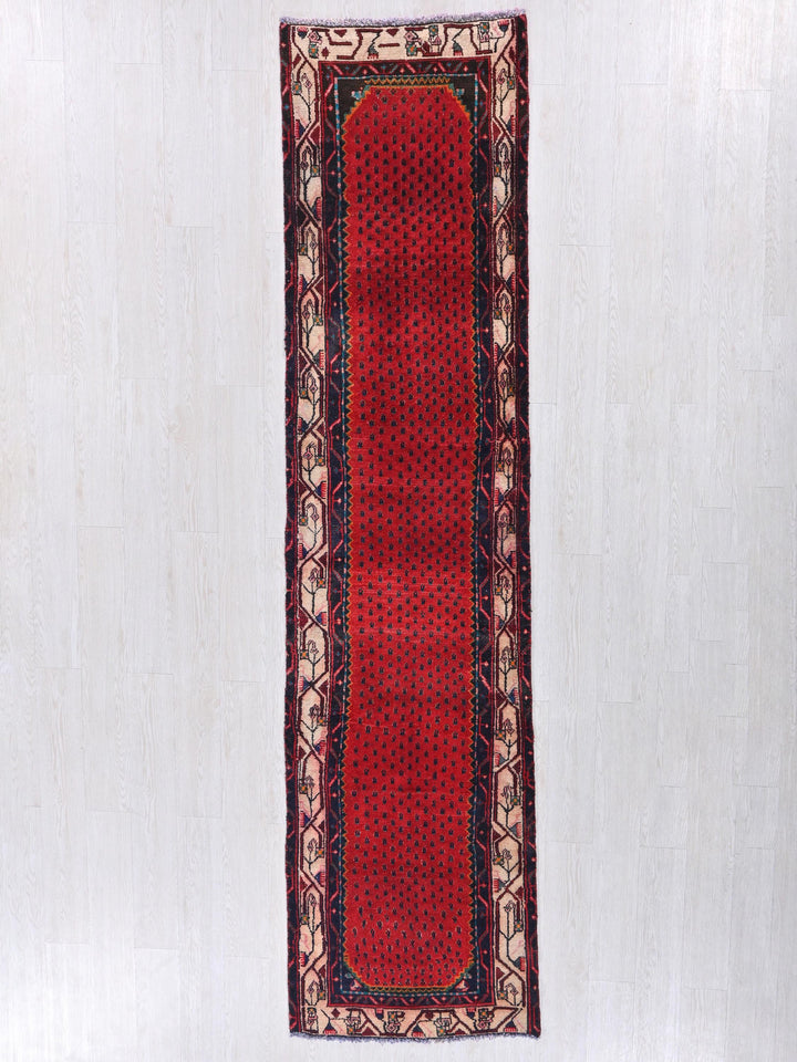 a red rug hanging on a white wall