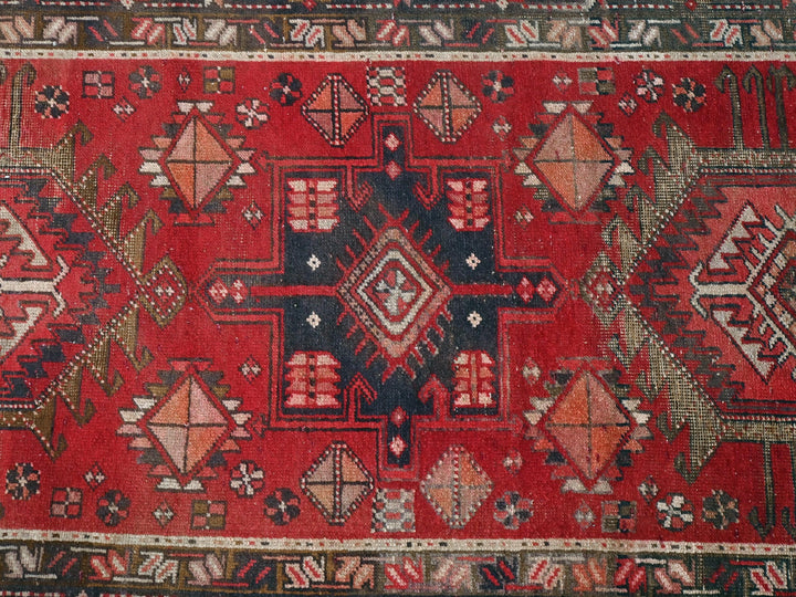 a red rug with many different designs on it