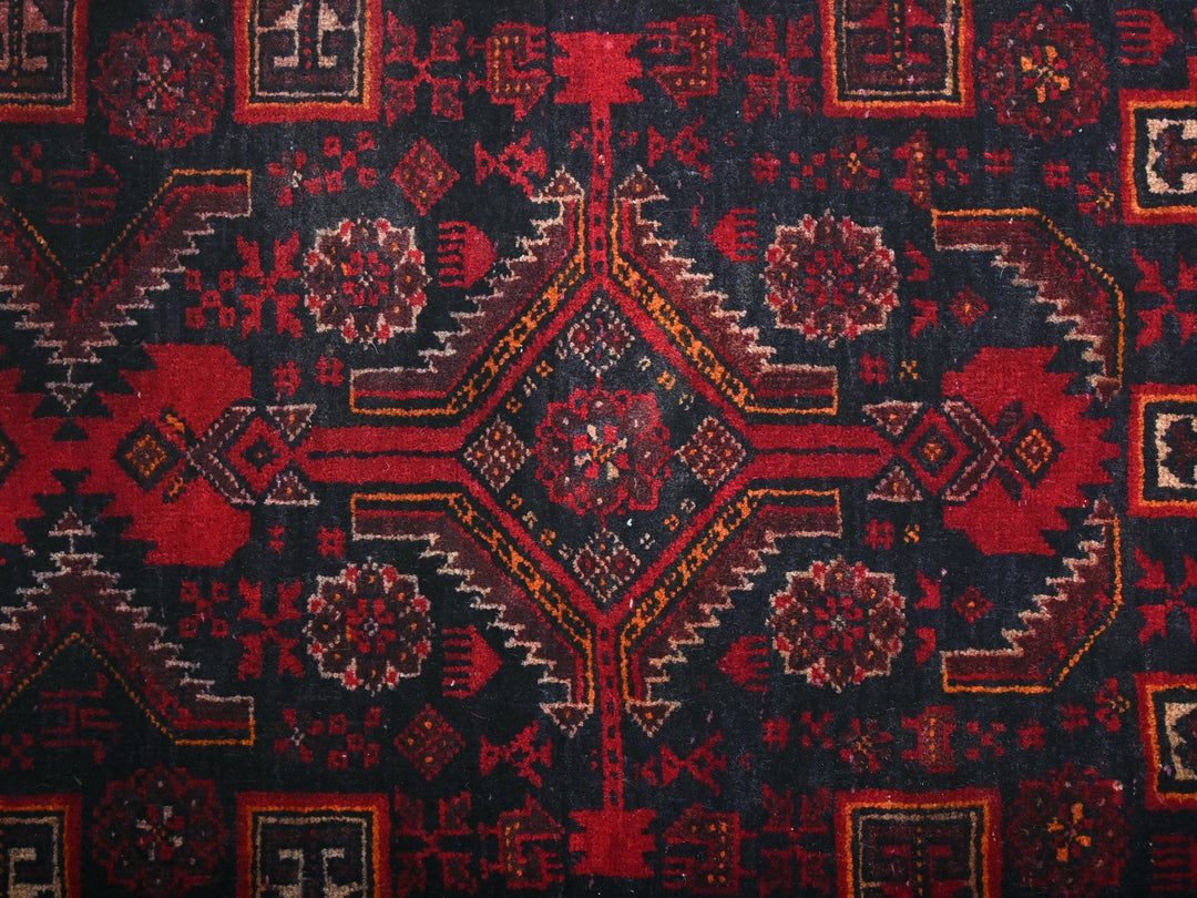 a close up of a red and black rug