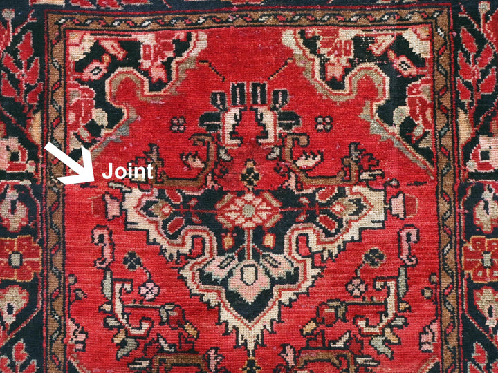 a close up of a red rug with a black border