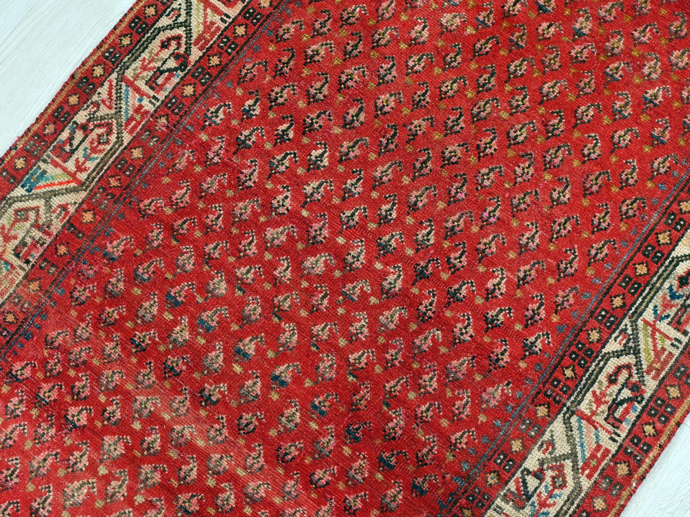 a red rug on a white wooden floor