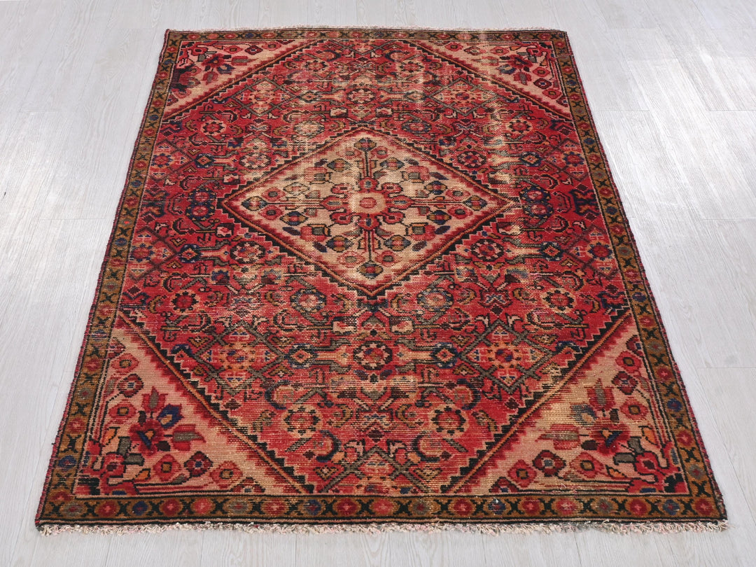 a red rug on a white floor with a wooden floor