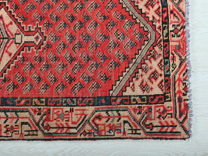 a red and black rug with a pattern on it