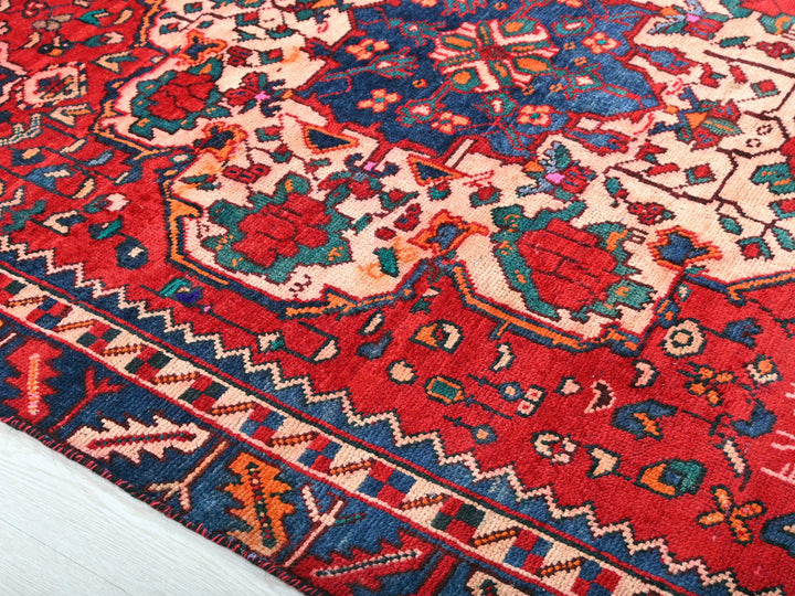 a red rug with a blue and red design on it