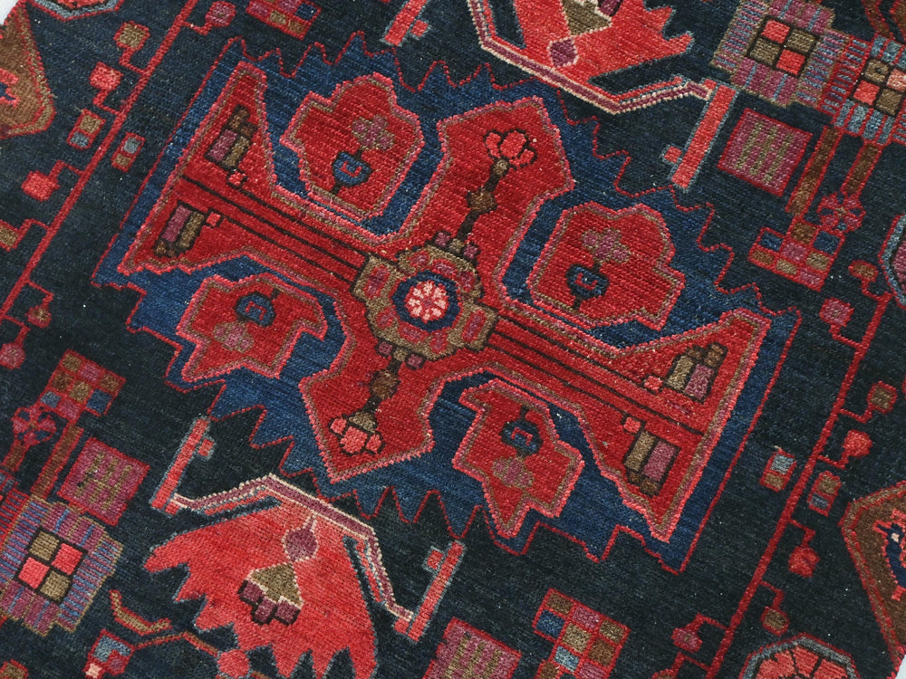 a close up of a blue and red oriental rug