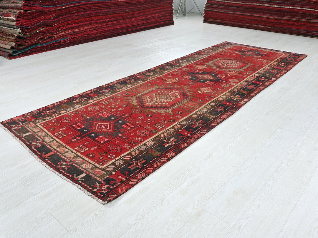 a pile of red rugs sitting on top of a white floor