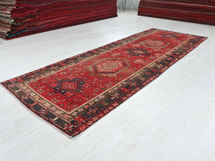 a pile of red rugs sitting on top of a white floor