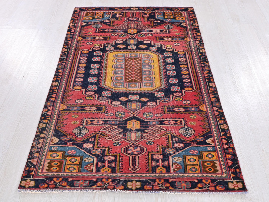 a red and blue rug on a white floor