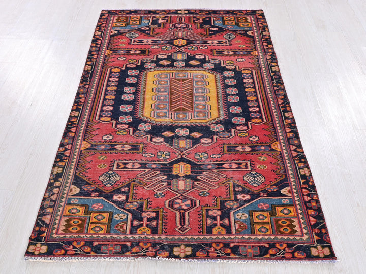 a red and blue rug on a white floor