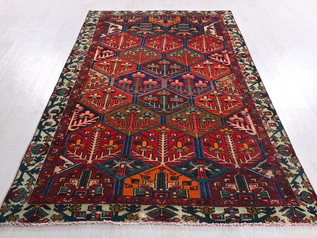 a red and blue rug on a white floor
