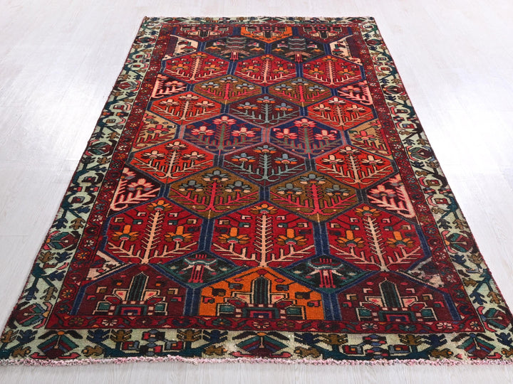 a red and blue rug on a white floor