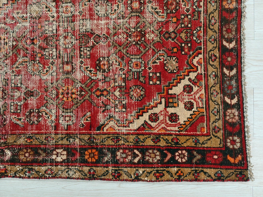 a red rug with many different designs on it