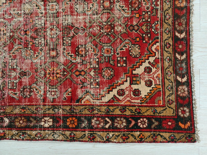 a red rug with many different designs on it