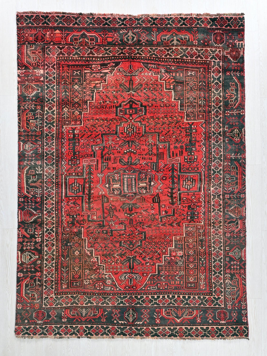 a red and black rug with a design on it