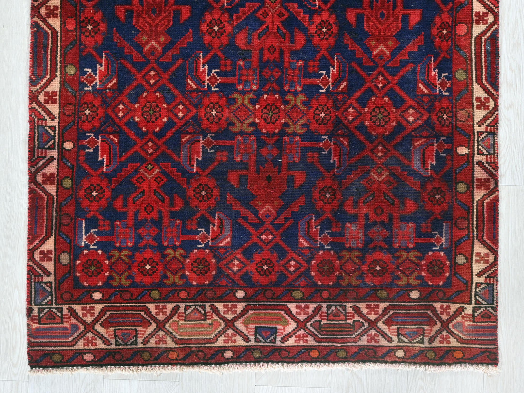 a red and blue rug on a white floor