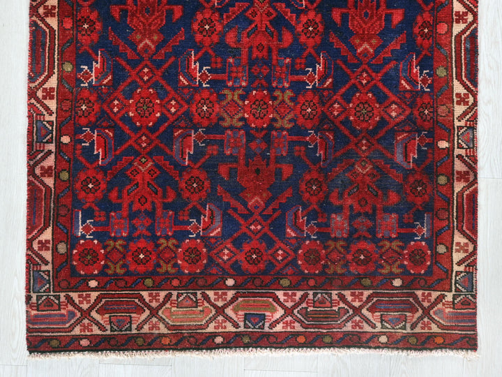 a red and blue rug on a white floor