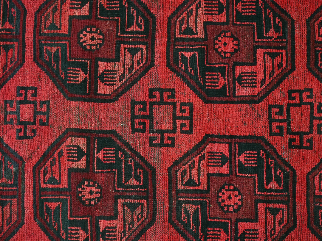 a close up of a red and black rug