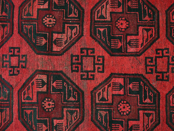 a close up of a red and black rug