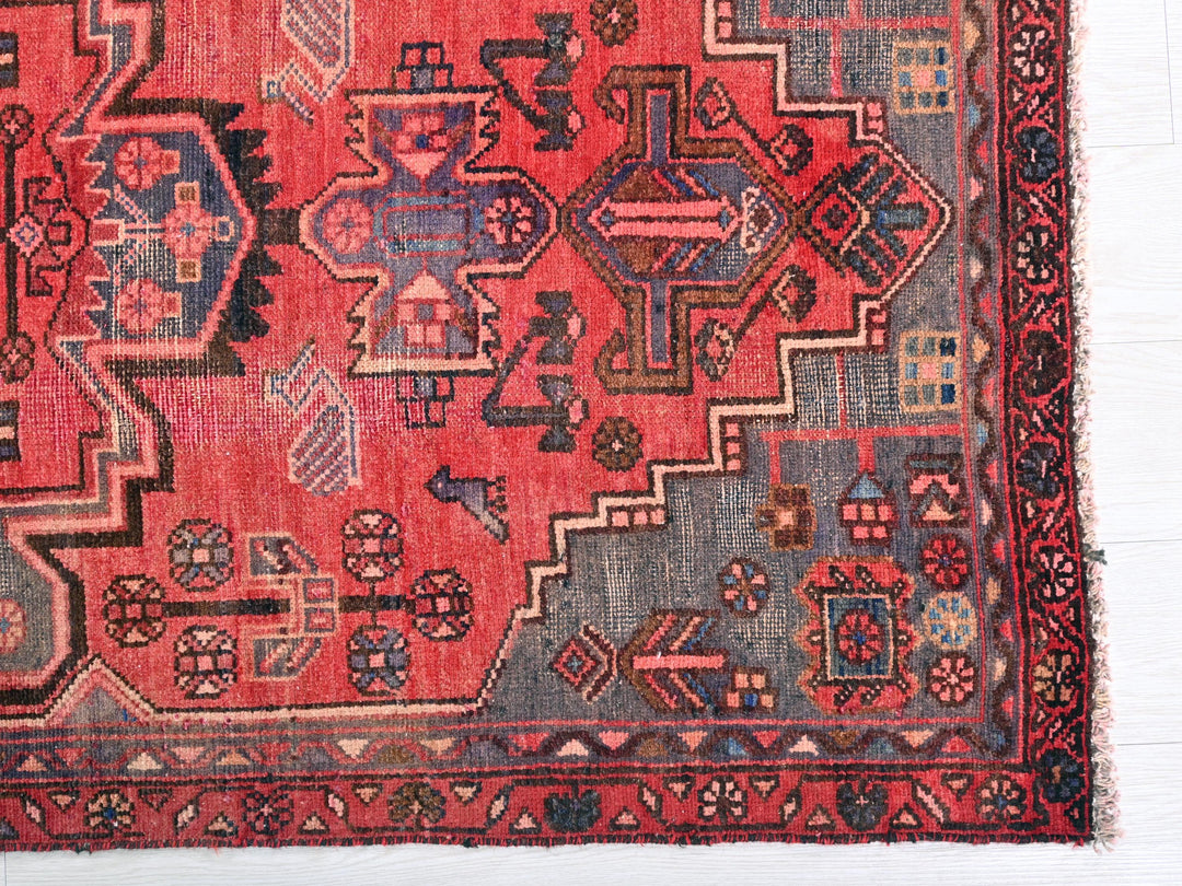 a red rug with a design on it