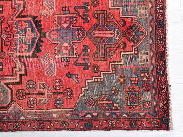a red rug with a design on it