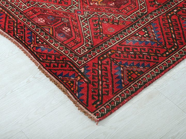 a red rug on the floor of a room