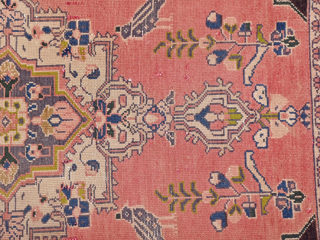 a pink rug with a floral design on it