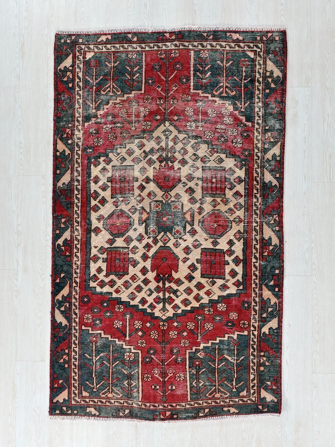 a red and blue rug on a white floor