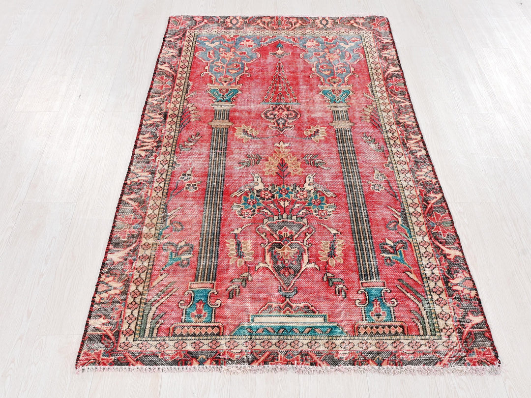 a red rug with a design on the middle of it