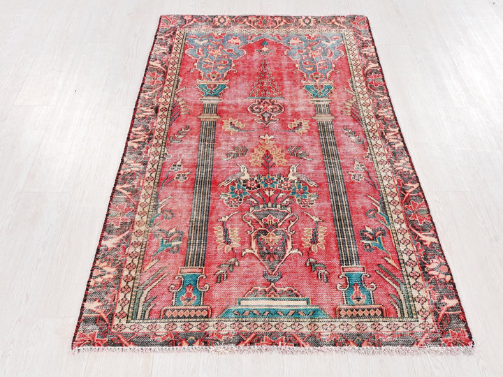 a red rug with a design on the middle of it